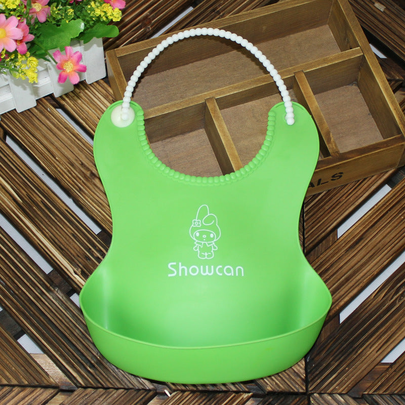 Green silicone baby bib by Baby Bliss Haven, featuring an adorable character design and practical waterproof material for feeding infants.