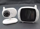 Close-up of a white baby monitor camera and screen, highlighting its sleek design.