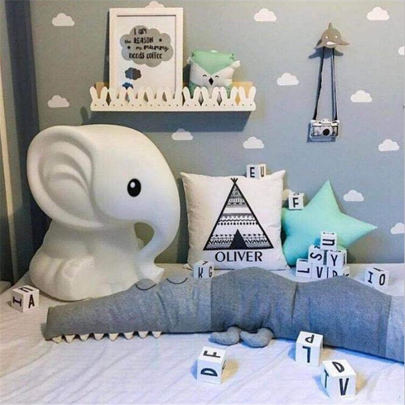 A peaceful sleeping baby surrounded by gray cartoon baby bedding from Baby Bliss Haven, designed to ensure comfort and safety for infants.