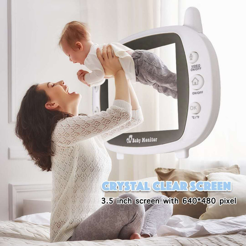 Mother playing with her baby, with a visible baby monitor displaying activity.