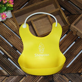 Yellow silicone baby bib by Baby Bliss Haven, made for stylish and practical feeding, decorated with a playful character.